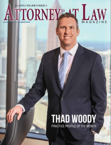 photo of Attorney Thad Woody standing in front of a window